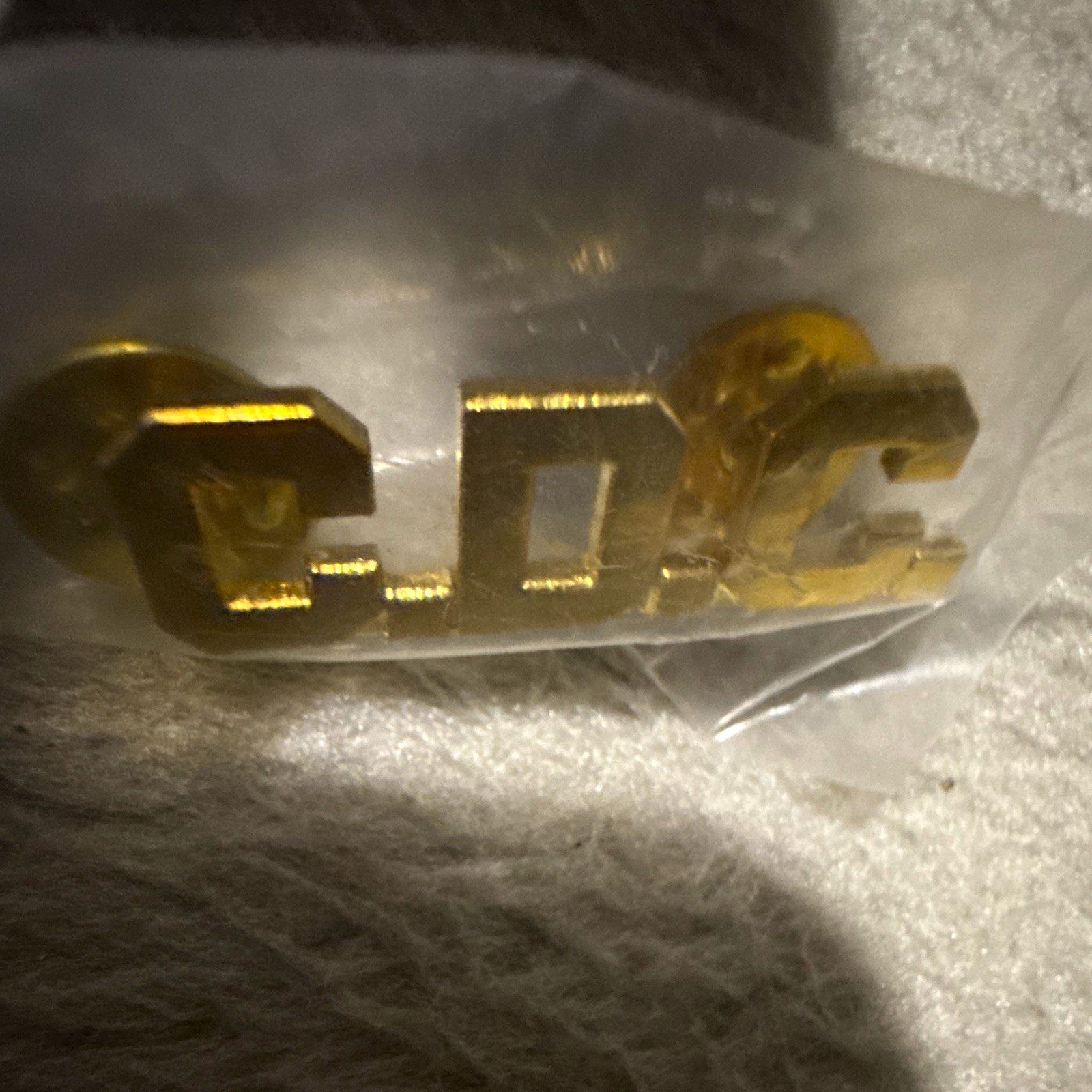 Gold Tone CDC Letter Pinback Button