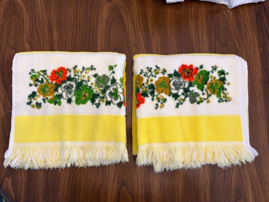 Two vintage yellow bath towels with orange and green flower trim