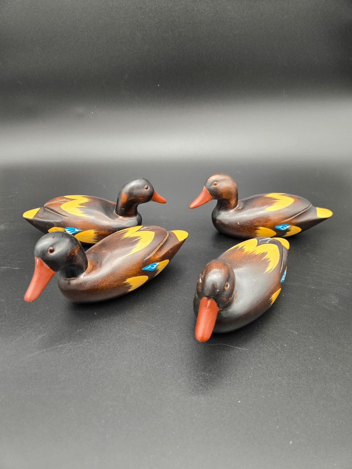 VINTAGE HAND PAINTED WOODEN DUCKS WITH GLASS EYES SET OF 4