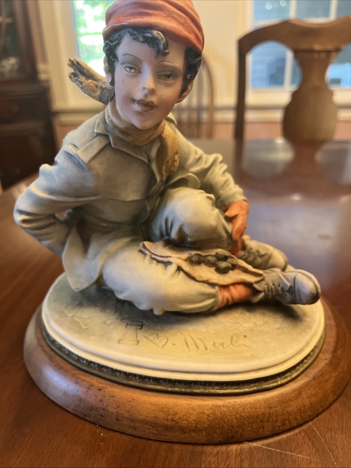 B Merli Capps Figurine of A boy Either A Dog