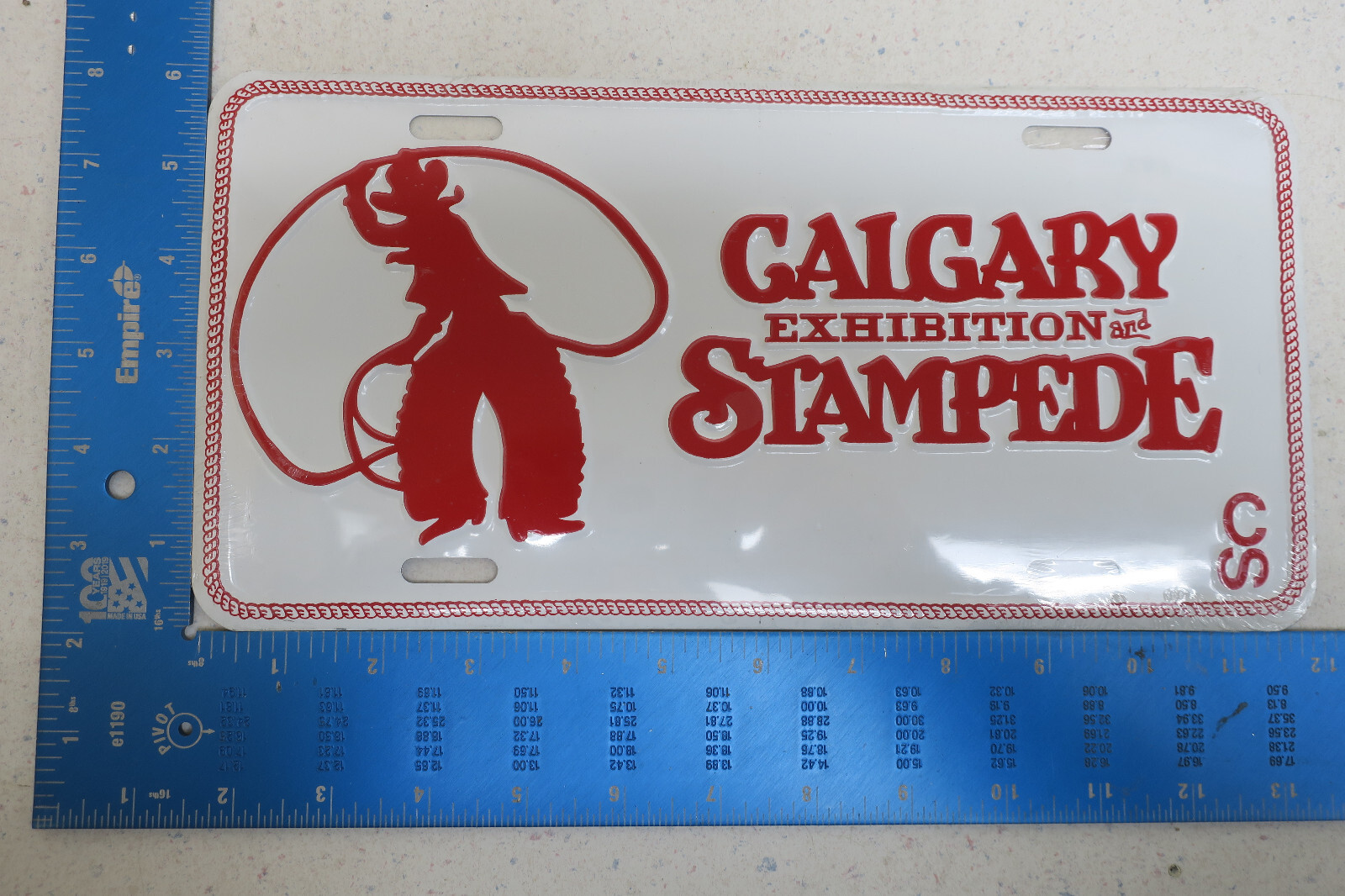NOS CALGARY ALBERTA EXHIBITION STAMPEDE METAL BOOSTER LICENSE PLATE EMBOSSED BB1