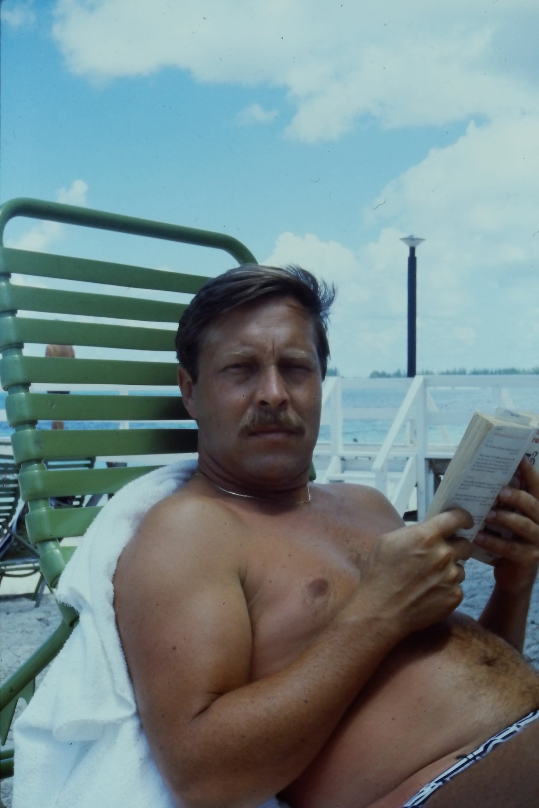 c1970\'s 35mm Slide, Man Reading Book Beach Chair Vacation green blue Color Photo