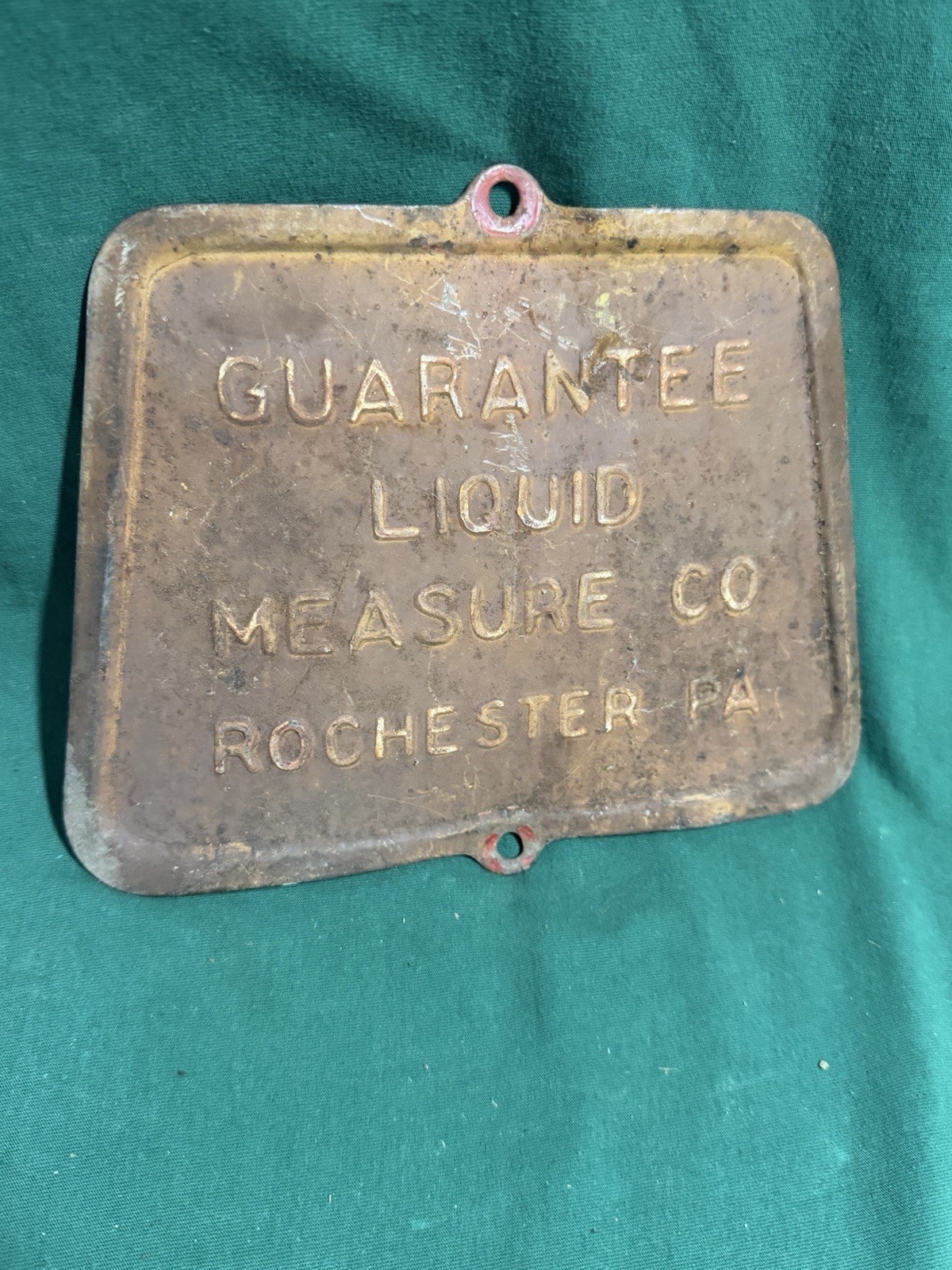 antique cast-iron access door or nameplate from a Guarantee Liquid Measure Co.