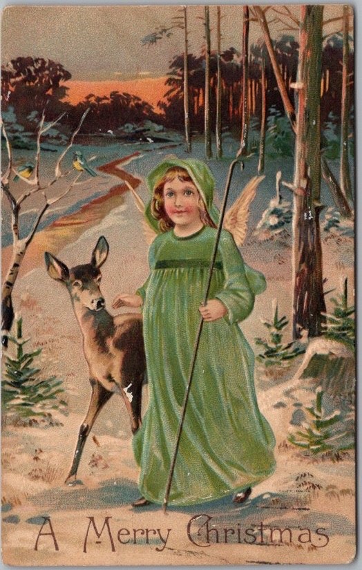 c1910s CHRISTMAS Postcard Angel Girl in Green Dress with Deer in the Woods