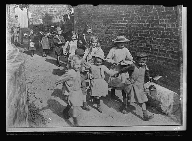 Photo:1910s Children Walking Alley Group Portrait Street Scene